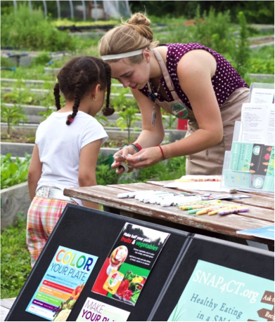 woman helping child at farmers market