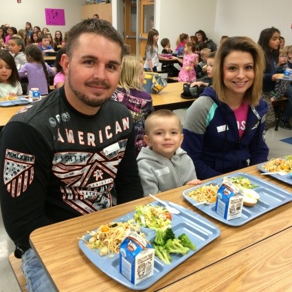 parents sit and eat with kids