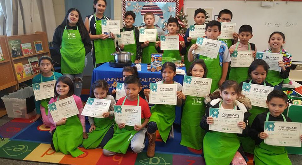 kids pose with nutrition education certificates