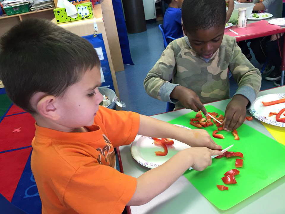 kids help to prepare red peppers