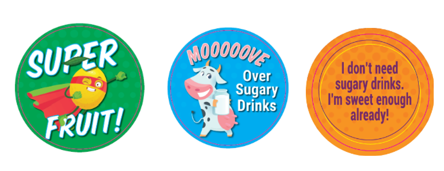 3 stickers: green background Super Fruit! with a lemon wearing a cape; blue background with a cartoon cow holding a glass of milk mooooove over sugary drinks; an orange background I don't need sugary drinks. I'm sweet enough already!