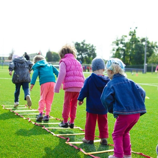 a line of children getting exercise outside