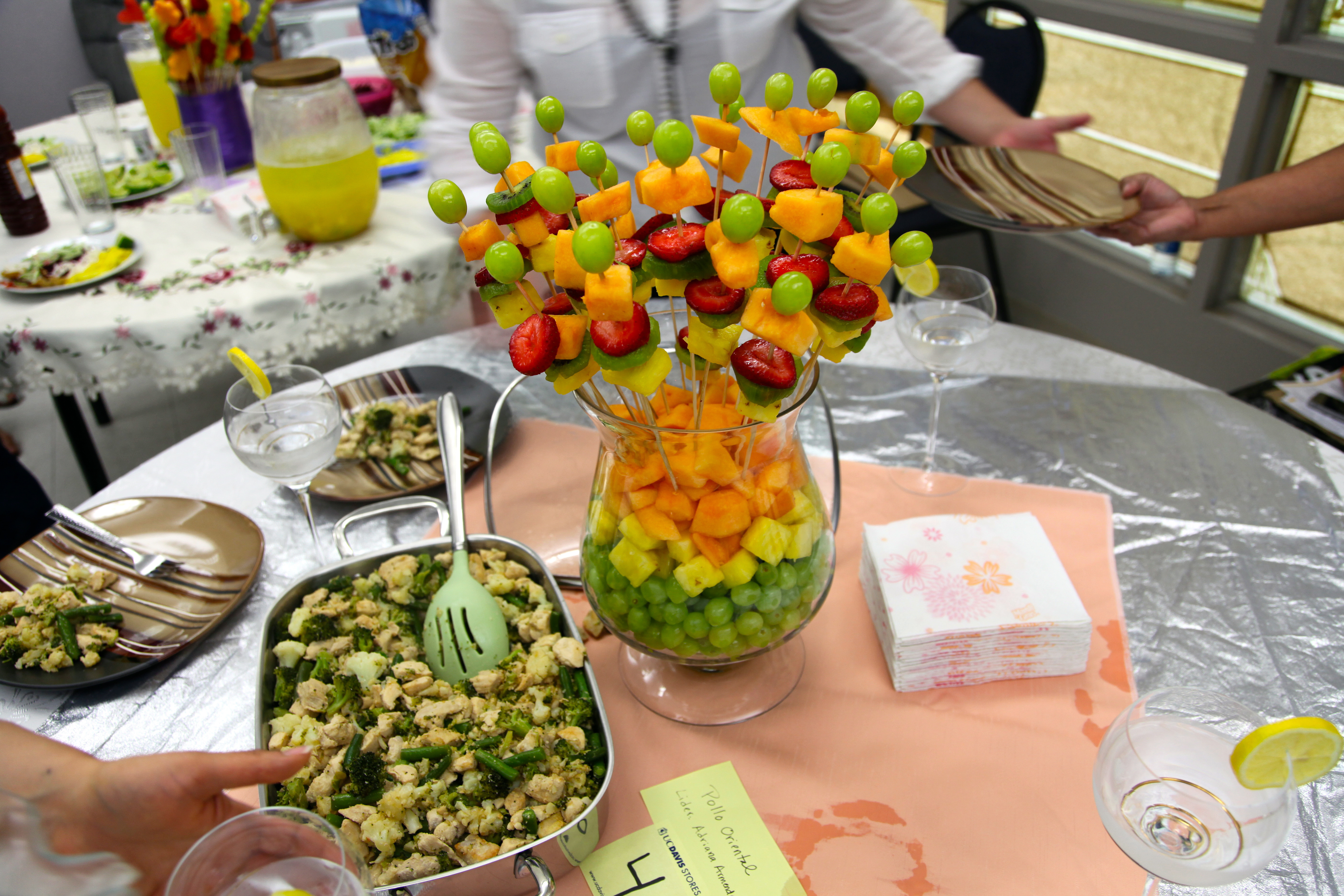 fruit kabobs in a bowl on a table