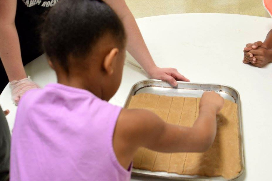 girl preparing food on a baking sheet