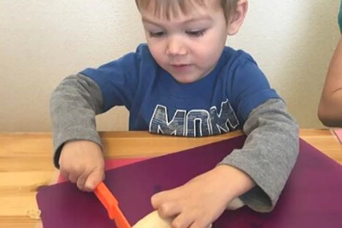 a boy slices a banana