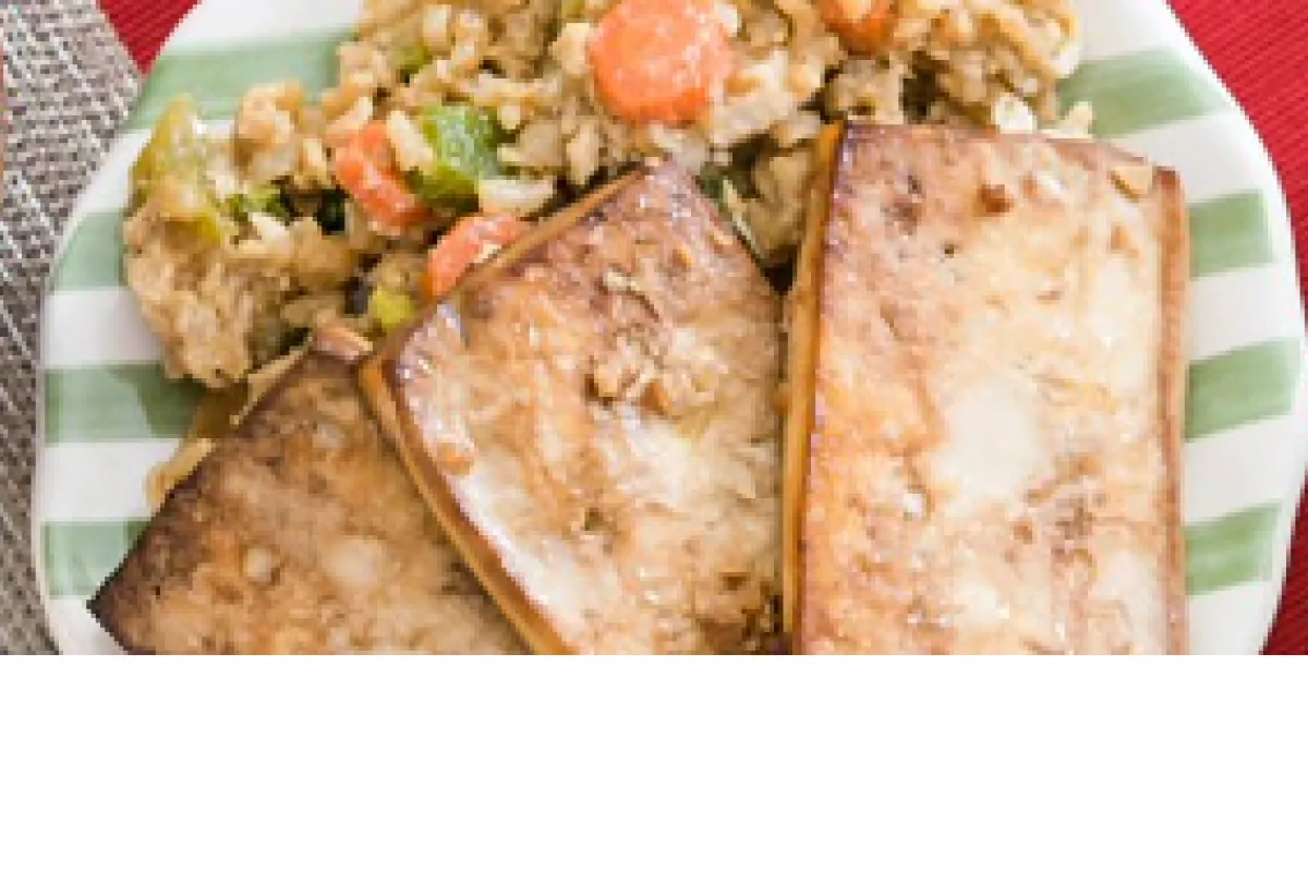 Lunar New Year menu: baked tofu and fried rice on a plate and a bowl of fruit