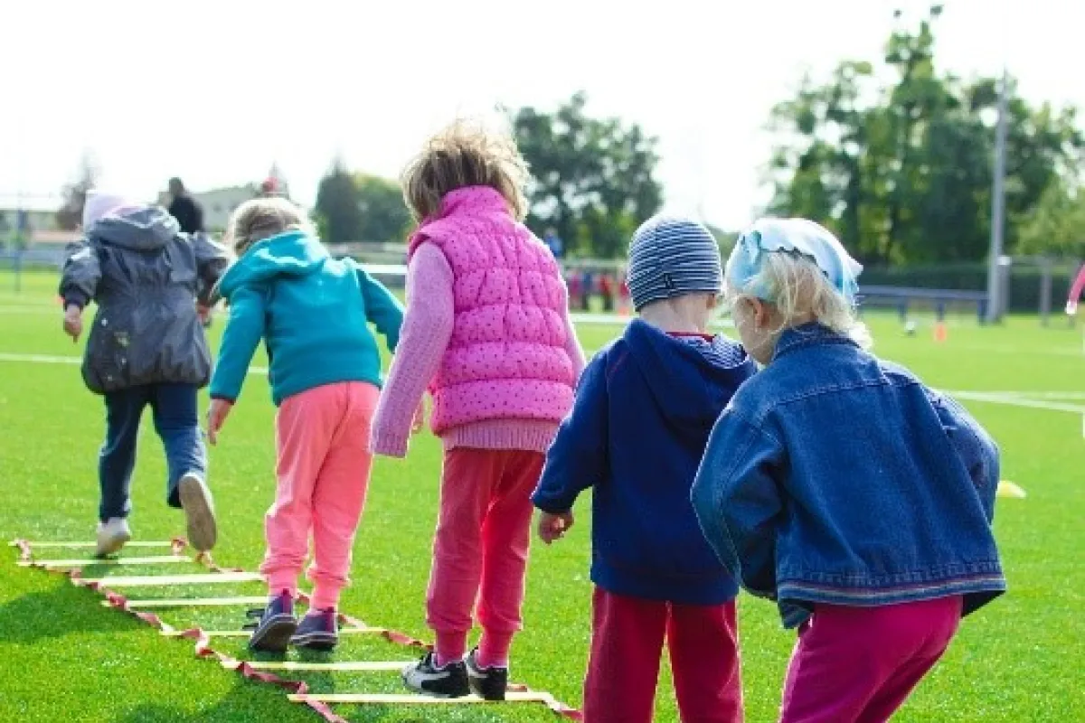 a line of children getting exercise outside