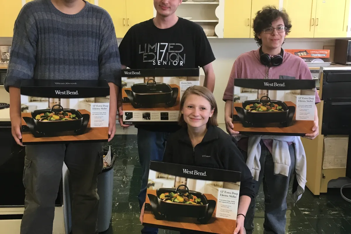 participants pose with their new electric skillets