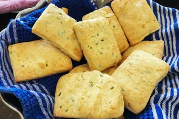 Chive Biscuits in a bowl with a towel
