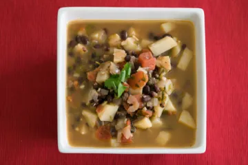 hearty mexican soup in a square white bowl