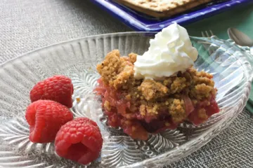 rhubarb cobbler on a plate with raspberries