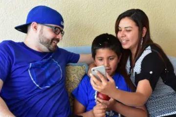 family looking at phone together