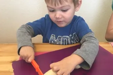 a boy slices a banana