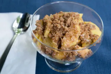 Peach crisp in a serving bowl