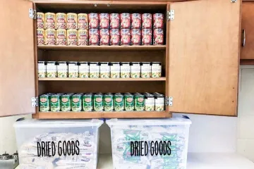 canned food displayed in a cabinet and dried goods are stored in bins