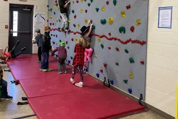 kids climbing on a rock climbing wall