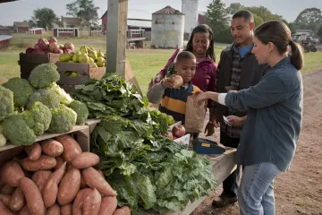 a family shops at a farmers market