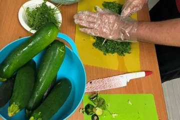 participants help to prepare food by chopping herbs