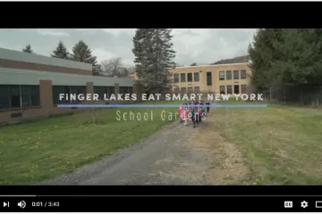 screen shot of beginning video with a farmer and school children
