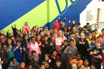 group of kids in a gym posing for a picture