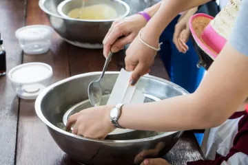 child and adult mixing something in a bowl