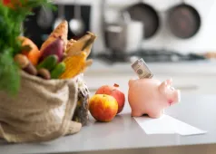 piggy bank with money in it and groceries