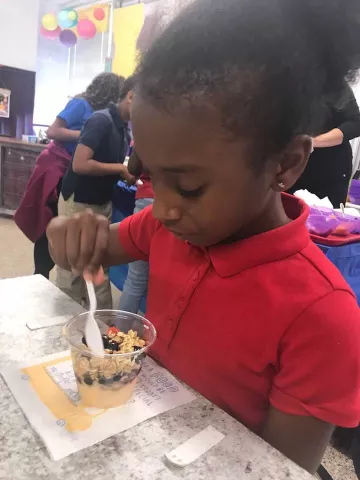 a student tries yogurt parfait