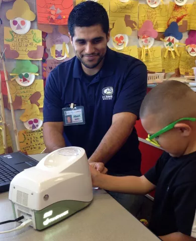 man helping a child participant