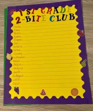 1st Grade 2-Bite Club on yellow background with a purple boarder; names written on each line down the page